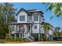 Charming two-story home with landscaped yard, porch, and stairs leading to the front door at 1537 Tomato Farm Cir, Mount Pleasant, SC 29464
