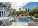 Beautiful pool with waterfall feature, lounge chairs, and lush landscaping for relaxation at 1537 Tomato Farm Cir, Mount Pleasant, SC 29464