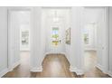 Bright foyer with wood floors, white walls, and doorways to other rooms, showcasing the home's layout at 1740 Agate Bay Dr, Mount Pleasant, SC 29466