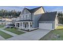 Beautiful two-story home with a covered porch, attached garage, and a lush green lawn at 199 Belfort Pl, Summerville, SC 29486