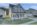 Inviting two-story home with a covered front porch and attached garage in a friendly neighborhood at 199 Belfort Pl, Summerville, SC 29486