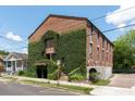 Brick building exterior covered in lush greenery with stairs leading to entrance at 2 Francis St # H, Charleston, SC 29403