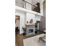 Cozy living room featuring a modern fireplace, high ceilings, and polished concrete floors at 2 Francis St # H, Charleston, SC 29403