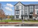 Stylish townhomes with a modern black and white design, enhanced by lush landscaping and a sidewalk at 207 Somerset Acres Dr, Summerville, SC 29486