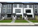 Attractive townhomes featuring a mix of gray and white siding, complemented by neatly kept lawns at 207 Somerset Acres Dr, Summerville, SC 29486