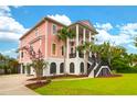 Beautiful two-story home featuring a grand entrance with stairs and columns, complemented by well-maintained landscaping at 2128 Breezy Point Dr, Mount Pleasant, SC 29466