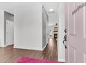 Bright entryway with a pink door, modern flooring, and a glimpse into the living spaces, creating a welcoming ambiance at 221 Trillium Ave, Summerville, SC 29483