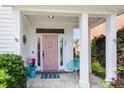 Inviting front porch with a pink door, stylish decor, and a welcoming atmosphere for relaxing and greeting guests at 221 Trillium Ave, Summerville, SC 29483