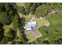 Overhead view of house with a circular driveway, white metal roof, surrounded by lots of trees at 225 Baxter Ln, Walterboro, SC 29488