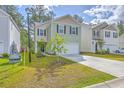 Charming two-story home with a well-manicured lawn and a two-car garage in a friendly neighborhood at 260 Sweet Cherry Ln, Summerville, SC 29486