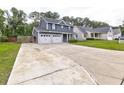 Long driveway to a charming two-story home with an attached two-car garage at 321 Houston Dr, Ladson, SC 29456