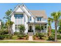 Beautiful two-story home with white siding, a covered front porch, and well manicured landscaping at 3741 Juneberry Ct, Mount Pleasant, SC 29466