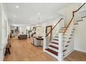 Open-concept living space with a staircase, dining area, and modern kitchen at 416 Barbadian Way, Mount Pleasant, SC 29464