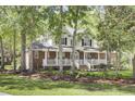 Elegant two-story home with a charming front porch, showcasing a well-maintained exterior and inviting curb appeal at 4217 Meadowbrook Ct, North Charleston, SC 29420