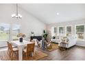 Bright, open-concept living and dining area with wood floors, natural light, and contemporary furnishings at 453 White Magnolia St, Moncks Corner, SC 29461