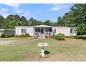 Beautiful home featuring a charming front porch with a white picket fence at 454 Pooshee Plantation Way, Bonneau, SC 29431