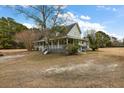 Charming home with a large yard and wraparound porch at 4689 Causey Pond Rd, Awendaw, SC 29429