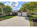 Beautiful brick home featuring a well-kept lawn, mature trees, and a spacious driveway at 486 Maple Oak Ln, Charleston, SC 29414