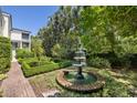 Beautifully landscaped garden with a tiered fountain and manicured boxwoods at 5 Logan St, Charleston, SC 29401