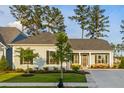 Charming home with a manicured lawn and lovely front porch seating at 504 Marsh Cove Cir, Summerville, SC 29486