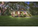 Charming home with inviting porch, American flag, and lush lawn, showcasing curb appeal at 5126 Highway 174, Hollywood, SC 29449