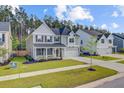 Beautiful two-story home with lush lawn and landscaping, featuring a welcoming front porch and attached two-car garage at 596 Dunswell Dr, Summerville, SC 29486