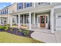Inviting front porch with decorative plants, stylish door, and charming details creating a warm and welcoming entrance at 596 Dunswell Dr, Summerville, SC 29486
