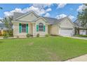 Attractive single-story home featuring a green lawn, an attached garage, and eye-catching green shutters at 6179 Fieldstone Cir, Charleston, SC 29414