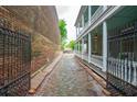 Cobblestone pathway and a lush view of a porch in this charming neighborhood at 66 Beaufain St, Charleston, SC 29401