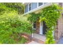 Inviting front porch with lush greenery and brick accents at 680 Buckhall Ct, Mount Pleasant, SC 29464