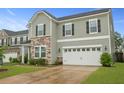 Well-maintained home featuring a two-car garage and landscaped front yard at 700 Silver Moss Dr, Moncks Corner, SC 29461