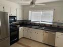 Well-lit kitchen with white cabinets, stainless steel appliances, and tile backsplash at 7733 Buck Pond Rd, North Charleston, SC 29418