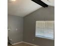 Living room with a vaulted ceiling, modern fan, and window with blinds at 7733 Buck Pond Rd, North Charleston, SC 29418