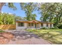 A single-story home featuring a brick exterior and a well-maintained front yard and driveway at 841 Fred St, Charleston, SC 29412