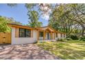 A beautiful single-story home featuring a brick exterior and a well-maintained front yard and driveway at 841 Fred St, Charleston, SC 29412