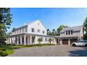 Inviting exterior with a long porch, manicured lawn, garage, and a paved driveway leading to the home's entrance at 952 Mccants Dr, Mount Pleasant, SC 29464