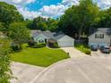 Aerial view of a one-story home with green lawn, nice shrubbery, and an attached two-car garage on a cul-de-sac at 9590 Crosscut Dr, Ladson, SC 29456