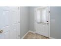 Entryway featuring neutral walls, tiled floors, a white front door with a curtain, and a closet at 100 Pine Hall Dr, Goose Creek, SC 29445