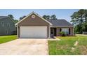 Single-story home with neutral siding, dark roof, attached garage, and a well-maintained front lawn at 100 Pine Hall Dr, Goose Creek, SC 29445