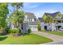 Charming two-story home with a well-manicured lawn and a convenient two-car garage at 104 Wando Reach Rd, Wando, SC 29492