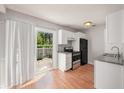 Bright kitchen featuring white cabinets, stainless appliances, and sliding door to patio at 111 Elmwood Ave # A, Ladson, SC 29456