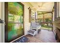 Inviting porch features a ceiling fan, stylish seating, and unique accents, perfect for relaxing at 1125 Oceanview Rd, Charleston, SC 29412