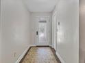 Bright entrance hallway with a patterned rug, white door with glass inserts, and neutral paint, creating a welcoming space at 1129 Belvedere Ter, Mount Pleasant, SC 29464
