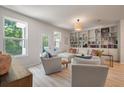 Bright living room with built-in bookshelves, light wood floors, and comfortable seating at 114 Rowans Creek Dr, Charleston, SC 29492