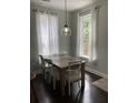 Bright dining room with a wooden table, white chairs, and modern lighting at 1199 Landau Ln, Mount Pleasant, SC 29466