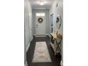 Inviting entryway featuring dark hardwood floors, console table, and a stylish area rug at 1199 Landau Ln, Mount Pleasant, SC 29466