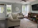 Comfortable living room with large windows, plush sofa, and contemporary decor at 1199 Landau Ln, Mount Pleasant, SC 29466