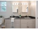 Modern bathroom featuring double sinks, granite countertops, and stylish fixtures at 1224 Midvale Ave, Charleston, SC 29412