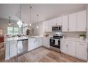 Bright kitchen featuring white cabinets, stainless steel appliances, and hardwood floors at 1224 Midvale Ave, Charleston, SC 29412