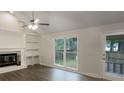 Bright living room showcasing a fireplace, built-in shelves, and large windows at 123 Lewisfield Dr, North Charleston, SC 29418